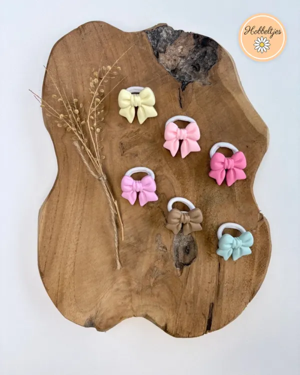 Zes haarelastiekjes met strikjes in geel, roze, fuchsia, taupe en mintblauw